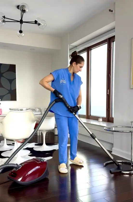 Professional home cleaner refreshing a bright modern home
